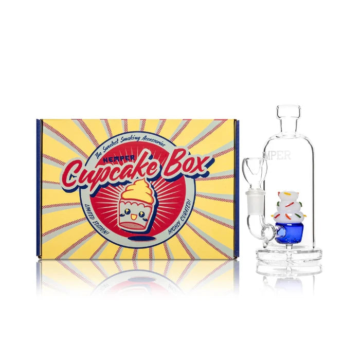 Hemper Cupcake Bong 6″ with matching illustrated box, featuring a colorful cupcake-shaped glass bong with frosted icing details.