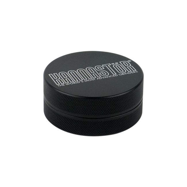 Kannastör® 2 Parts 56mm Black Grinder, closed and placed flat.