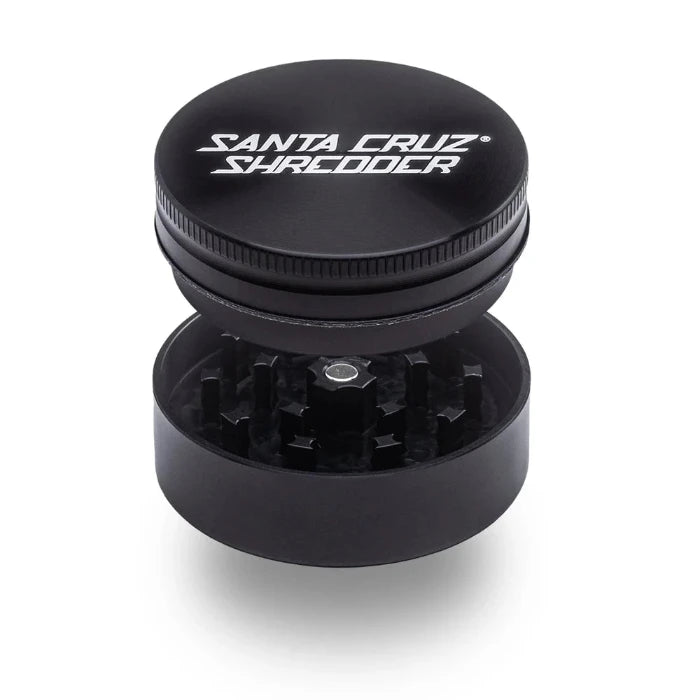 Santa Cruz Shredder® Metal 2 Parts 54mm Black Grinder, open, posed flat to show interior.