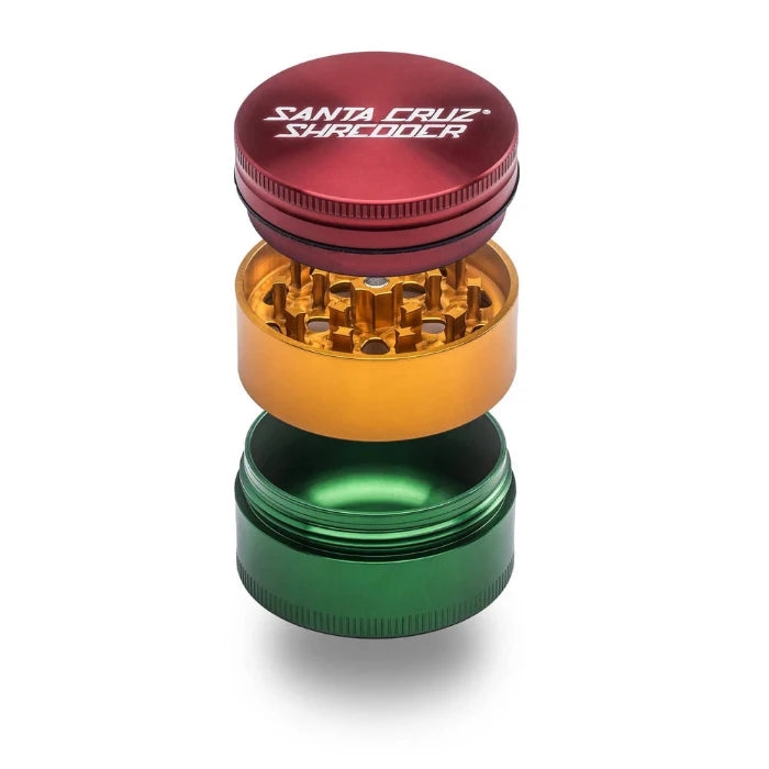 Santa Cruz Shredder® Metal 3 Parts 54mm Rasta Grinder, open, posed flat to show interior.