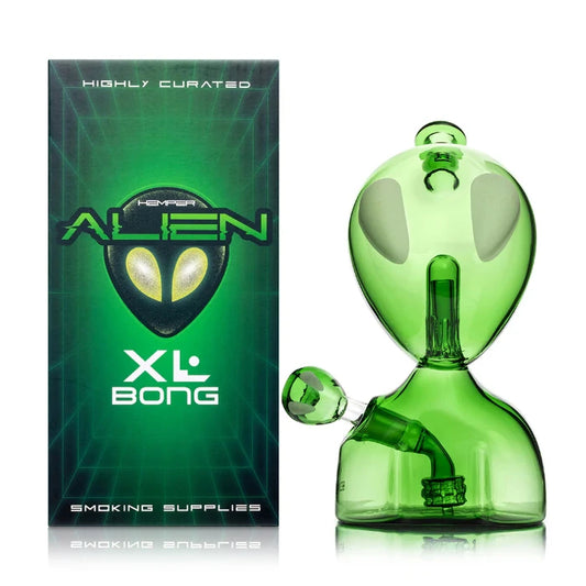 Hemper Alien XL Bong 9.1″ with matching illustrated box, featuring an extraterrestrial-inspired design with glowing green details and a sleek glass finish.