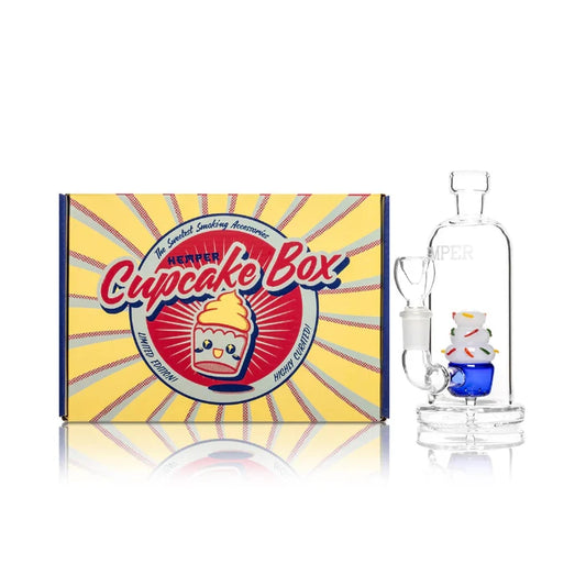 Hemper Cupcake Bong 6″ with matching illustrated box, featuring a colorful cupcake-shaped glass bong with frosted icing details.