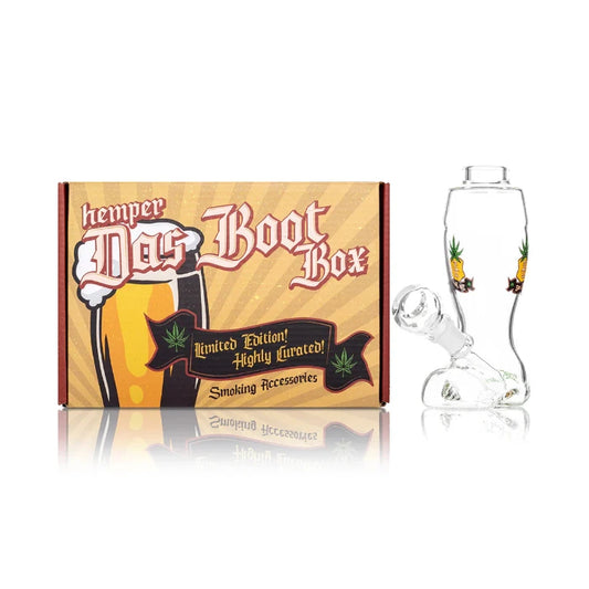 Hemper Das Boot Bong 6″ with box, shaped like a classic boot with clear glass design and detailed toe and heel elements.