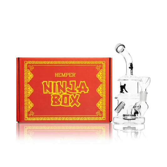 Hemper Ninja Rig Bong 7″ with matching illustrated box, featuring a stealthy ninja-inspired glass rig with sleek black design and sharp details.