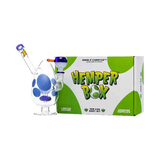 Hemper Spotted Egg Bong 7″ with matching illustrated box, featuring a colorful egg-shaped glass bong with playful spots and a unique design.