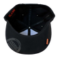 Bottom view of RAW® Flat Bill Snap Back Hat with Black Logo and Poker, showing the poker tool compartment.